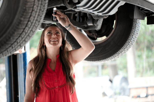 Auto Repair Gainesville - Image of Rachael, the owner, inspecting a vehicle.
