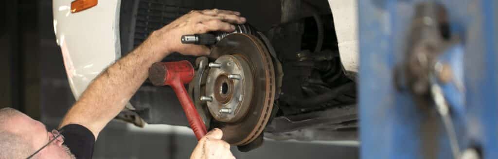 Mechanic working on a brake rotor.