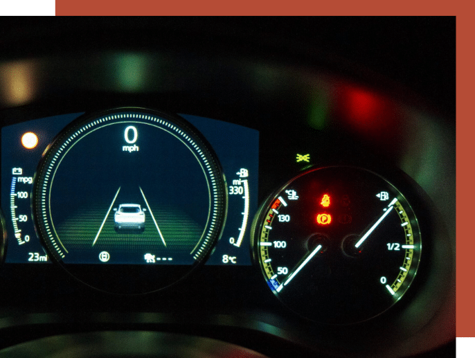 Engine Repair - Picture of a car's dashboard display illuminated during nighttime driving conditions. it shows an error that indicates the car may need a diagnostic test.