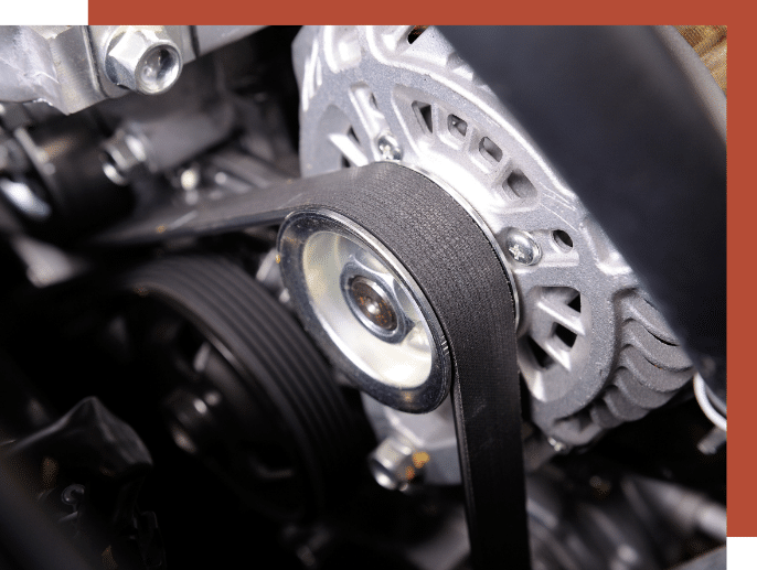 internal view of a car engine's belt being pulled through the engine